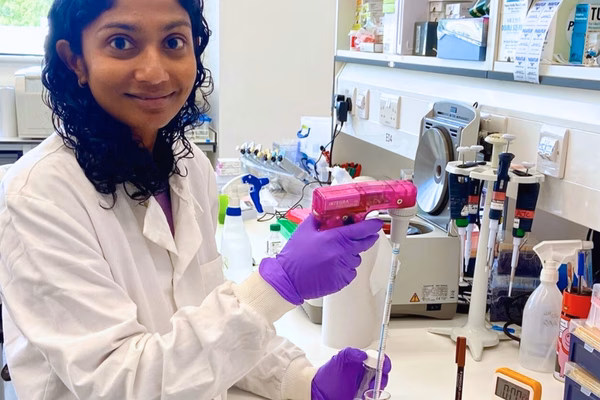Wellbeing of Women researcher, Dr Roseanne Rosario, standing in a laboratory