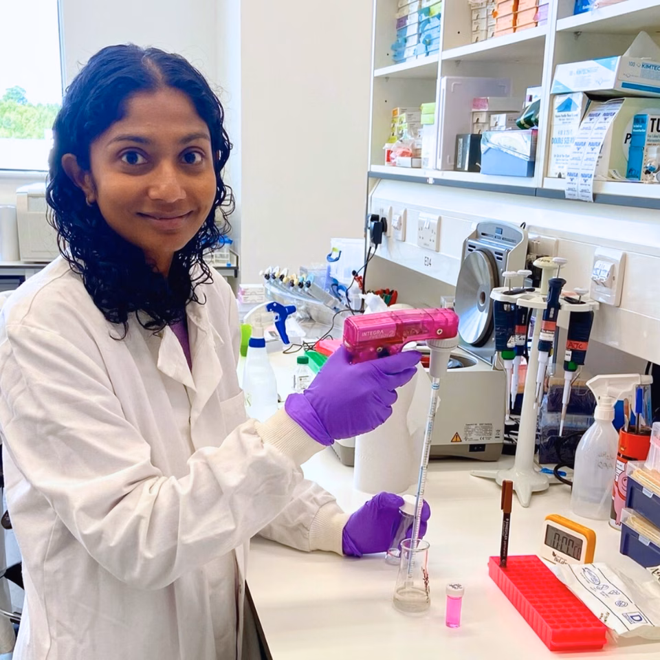 Wellbeing of Women researcher, Dr Roseanne Rosario, standing in a laboratory