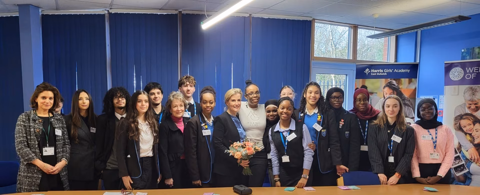 HRH The Duchess of Edinburgh, standing with a group of secondary school children; boys and girls. With Professor Dame Lesley Regan and Tanya Simon Hall
