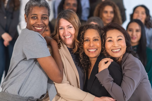 Middle aged women linking arms