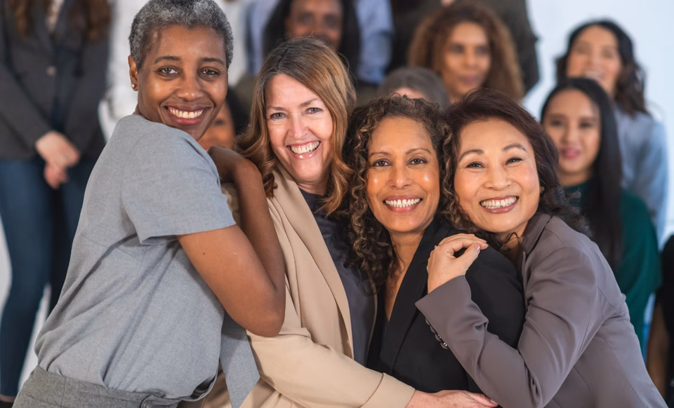 Middle aged women linking arms