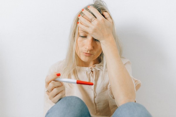 A women looking down at her pregnancy test