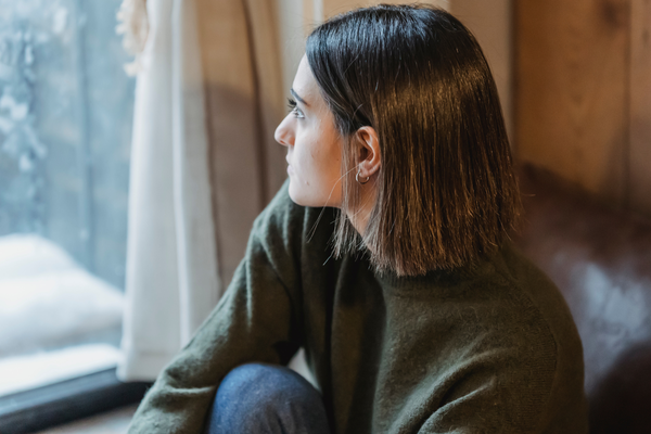 Woman looks out of window